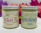 2 hand poured candles with labels that each say What If and Celebrate with white lids and bright floral background.