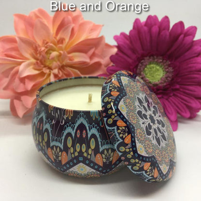Hand-poured candle in blue and orange mandala tin with matching lid with peach and purple floral background.