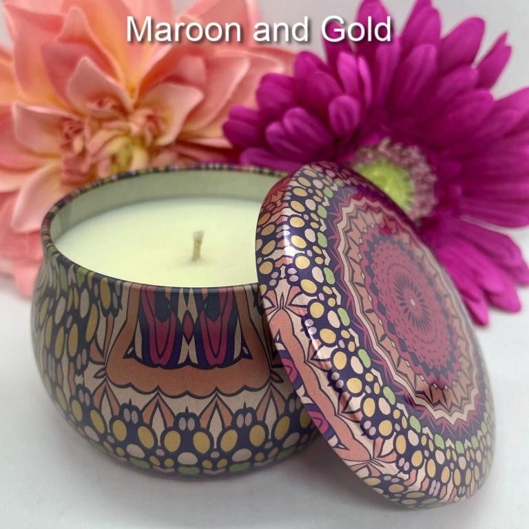 Hand-poured candle in maroon and gold mandala tin with matching lid with peach and purple floral background.